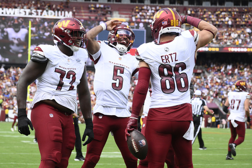 Washington Commanders tight end Zach Ertz (86) celebrating his touchdown with quarterback Jayden Daniels (5) and offensive tackle Josh Conerly Jr. (72) during the first half of an NFL football game against the New York Giants, Sunday, Sept. 7, 2025, in Landover, Md. (AP Photo/Nick Wass)
