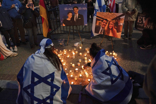 FILE - People gather to light candles in a makeshift memorial to honor Yaron Lischinsky and Sarah Milgrim who were killed as they left an event at the Capital Jewish Museum in Washington, during a candlelight vigil outside of the White House in Washington, Thursday, May 22, 2025. (AP Photo/Jose Luis Magana, File)