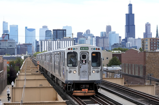 FILE - A Chicago Transit Authority train pulls into the Damen Ave. station on Aug. 12, 2024, in Chicago. (AP Photo/Charles Rex Arbogast, File)