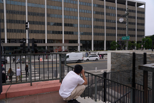 FILE - People line up outside the Los Angeles Federal Building in Los Angeles, housing the U.S. Immigration and Customs Enforcement (ICE) and U.S. Citizenship and Immigration Services (USCIS) on Wednesday, June 25, 2025. (AP Photo/Damian Dovarganes, file)