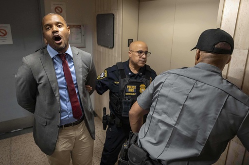 New York State Senator Jabari Brisport chants while detained by federal agents after demanding access to inspect the detainment facility at immigration court at the Jacob K. Javits federal building, Thursday, Sept. 18, 2025, in New York. (AP Photo/Yuki Iwamura)