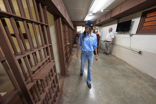 Homeland Security Secretary Kristi Noem, center, tours "Camp 57," a facility to house immigration detainees at the Louisiana State Penitentiary in Angola, La., Wednesday, Sept. 3, 2025. (AP Photo/Gerald Herbert, Pool)