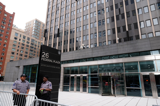 FILE - Security guards stand outside the Jacob K. Javits Federal Office Building at 26 Federal Plaza, Monday, Sept. 30, 2024, in New York. (AP Photo/Pamela Smith, file)