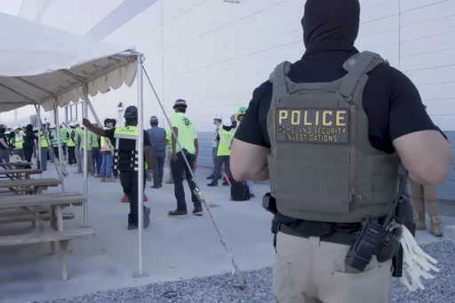 This image from video provided by U.S. Immigration and Customs Enforcement via DVIDS shows manufacturing plant employees being escorted outside the Hyundai Motor Group’s electric vehicle plant, Thursday, Sept. 4, 2025, in Ellabell, Ga. (Corey Bullard/U.S. Immigration and Customs Enforcement via AP)