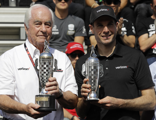 FILE - Car owner Roger Penske, left, and driver Will Power, of Australia, receive their "Baby Borg" trophies for winning last years race during the drivers meeting for the Indianapolis 500 IndyCar auto race at Indianapolis Motor Speedway, Saturday, May 25, 2019, in Indianapolis. (AP Photo/Darron Cummings, file)
