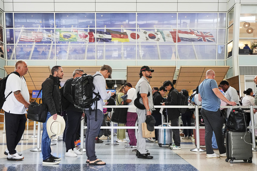 Travelers Stand in line at a security checkpoint before boarding their international flights at Dallas Fort Worth International Airport, Friday, Aug. 29, 2025, in DFW Airport, Texas. (AP Photo/Tony Gutierrez)