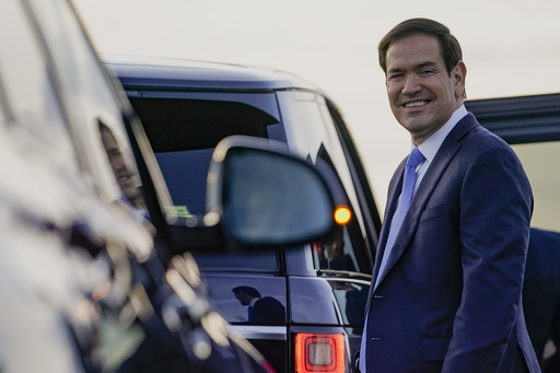 U.S. Secretary of State Marco Rubio smiles as he prepares to enter a vehicle upon arrival at London Stansted Airport, during an official visit near London, Tuesday, Sept. 16, 2025. (Nathan Howard/Pool Photo via AP)