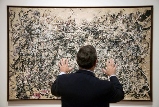 FILE - David Brenneman, director of collections and exhibitions at the High Museum, talks about Jackson Pollock's painting "Number 1A" on display as part of an exhibit in Atlanta, on Thursday, Oct. 6, 2011. (AP Photo/David Goldman, File)