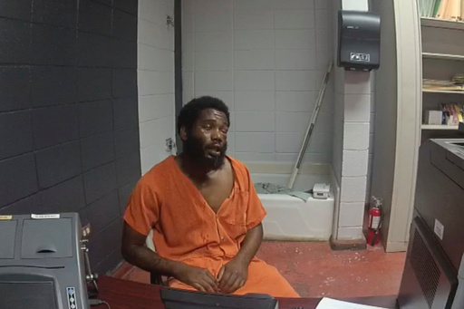 In this image from body camera video from the DeSoto Parish Sheriff's Office, Jarius Brown is interviewed following a jailhouse beating that left him with a bruised face, fractured eye socket and broken nose at the DeSoto Parish Detention Center in Mansfield, La., on Sept. 27, 2019. (DeSoto Parish Sheriff's Office via AP)