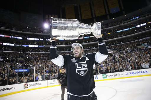 FILE - Los Angeles Kings center Anze Kopitar, of Slovenia, carries the Stanley Cup after beating the New York Rangers in double in Game 5 of the NHL Stanley Cup Final series, June 13, 2014, in Los Angeles. (AP Photo/Jae C. Hong, File)