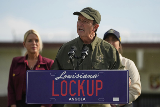 FILE - Louisiana Gov. Jeff Landry speaks to reporters outside "Camp 57," a facility to house immigration detainees at the Louisiana State Penitentiary in Angola, La., Wednesday, with Attorney General Pam Bondi, , left, and ICE Deputy Director Madison Sheahan, partially visible right, Sept. 3, 2025. (AP Photo/Gerald Herbert, File)