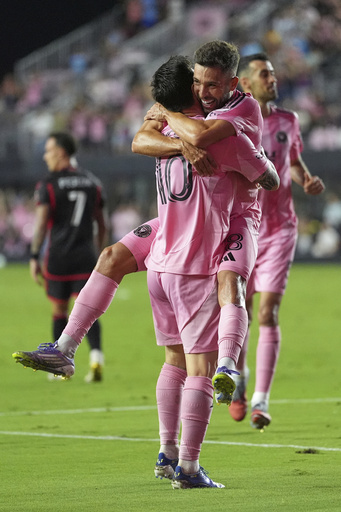 Inter Miami forward Lionel Messi (10) lifts defender Jordi Alba as he celebrates scoring his side's second goal against D.C. United during the second half of an MLS soccer match, Saturday, Sept. 20, 2025, in Fort Lauderdale, Fla. (AP Photo/Rebecca Blackwell)