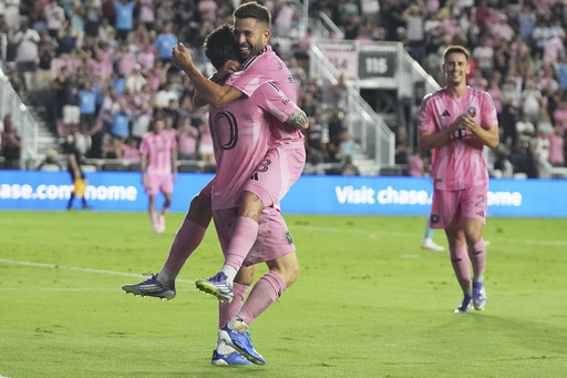 Inter Miami forward Lionel Messi, left, celebrates with defender Jordi Alba, right, after scoring a goal during the first half of an MLS soccer match against Seattle Sounders, Tuesday, Sept. 16, 2025, in Fort Lauderdale, Fla. (AP Photo/Lynne Sladky)