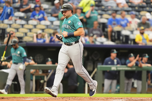Seattle Mariners' Cal Raleigh runs home to score on a double by Julio Rodriguez during the first inning of a baseball game against the Kansas City Royals, Tuesday, Sept. 16, 2025, in Kansas City, Mo. (AP Photo/Charlie Riedel)