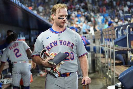 New York Mets' Pete Alonso gathers his belongings in the dugout after the Mets lost to the Miami Marlins in a baseball game, Sunday, Sept. 28, 2025, in Miami. (AP Photo/Lynne Sladky)