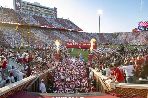 Oklahoma runs onto the field before an NCAA college football game against Michigan on Saturday, Sept. 6, 2025, in Norman, Okla. (AP Photo/Alonzo Adams)
