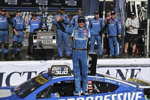 Denny Hamlin, center, celebrates after winning a NASCAR Cup Series auto race at World Wide Technology Raceway, Sunday, Sept. 7, 2025, in Madison, Ill. (AP Photo/Connor Hamilton)