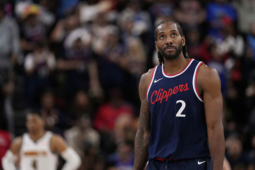FILE - Los Angeles Clippers forward Kawhi Leonard, right, looks toward the scoreboard during the second half of an NBA basketball game, May 1, 2025, in Inglewood, Calif. (AP Photo/Mark J. Terrill, file)