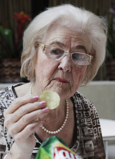 FILE - In this March 14, 2012 file photo, Marilyn Hagerty samples a Lays potato chip during an interview with The Associated Press in New York. (AP Photo/Mark Lennihan, File)