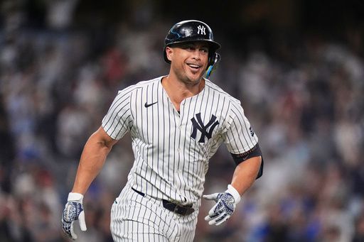 New York Yankees' Giancarlo Stanton smiles after hitting a two-run home run during the third inning of a baseball game against the Baltimore Orioles Friday, Sept. 26, 2025, in New York. (AP Photo/Frank Franklin II)