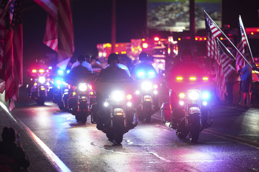 Police officers ride during a procession Wednesday, Sept. 17, 2025, in Spring Grove, Pa., after multiple police officers were shot and killed. (AP Photo/Matt Slocum)