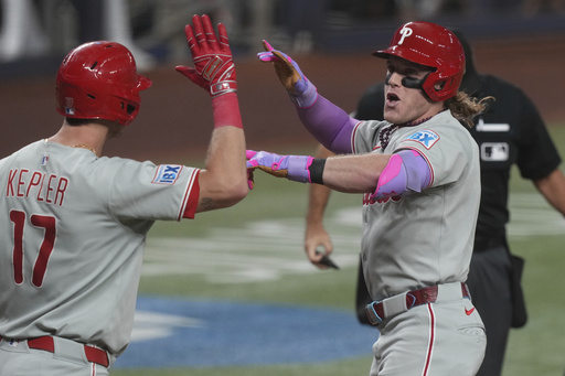 Philadelphia Phillies' Harrison Bader, right, celebrates with Max Kepler (17) after hitting a home run during the fourth inning of a baseball game against the Miami Marlins Friday, Sept. 5, 2025, in Miami. (AP Photo/Marta Lavandier)