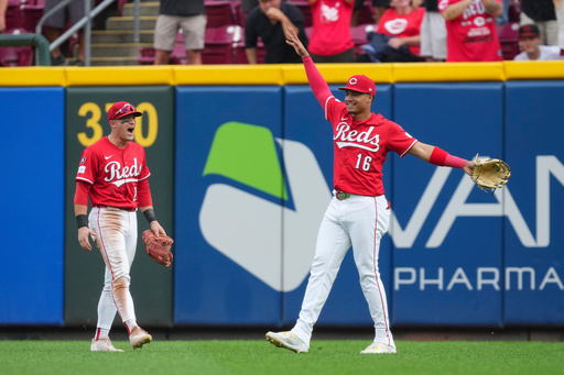 Cincinnati Reds outfielder Noelvi Marte (16) celebrates with teammate TJ Friedl (29) after catching a fly ball hit by Pittsburgh Pirates' Bryan Reynolds during the ninth inning of a baseball game, Thursday, Sept. 25, 2025, in Cincinnati. (AP Photo/Jeff Dean)