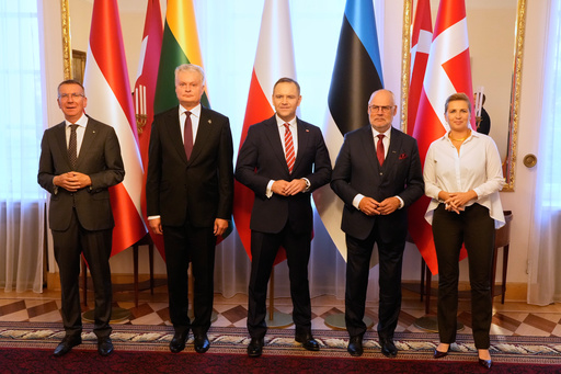 The Presidents of Latvia Edgars Rinkevics, 1st left, Lithuania President Gitanas Nausėda, second left, Estonia President Alar Karis, and the Prime Minister of Denmark Mette Frederiksen, right, pose at a meeting with Polish President Karol Nawrocki, center, in Warsaw, Poland, Thursday, Aug. 28, 2025. (AP Photo/Czarek Sokolowski)