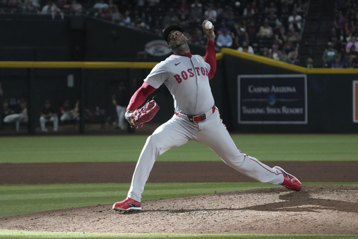 Boston Red Sox pitcher Aroldis Chapman throws against the Arizona Diamondbacks in the ninth inning during a baseball game, Sunday, Sept 7, 2025, in Phoenix. (AP Photo/Rick Scuteri)