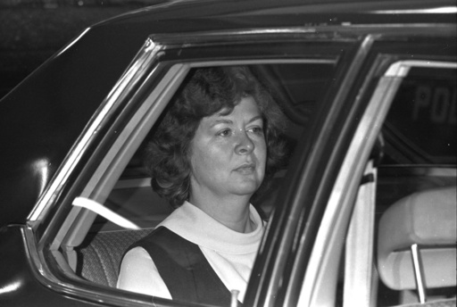 FILE - Sara Jane Moore rides in the backseat of a car on her way to federal court in San Francisco, Dec. 17, 1975, where a federal judge accepted her plea of guilty to the attempted assassination of President Ford. (AP Photo/Jim Palmer, File)