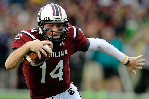 FILE - South Carolina quarterback Connor Shaw (14) runs for yardage during the first half of an NCAA college football game against Coastal Carolina, Nov. 23, 2013 in Columbia, S.C. (AP Photo/Stephen Morton, File)