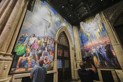 Photographers work during a media preview of the 25-foot-high mural by artist Adam Cvijanovic, the largest artwork ever commissioned for St. Patrick's Cathedral, in New York, Thursday, Sept. 18, 2025. (AP Photo/Richard Drew)