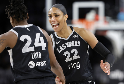 Las Vegas Aces center A'ja Wilson (22) congratulates guard Jewell Loyd (24) after Loyd scored a 3-point basket during the first half of Game 1 against the Seattle Storm in the first round of the WNBA basketball playoffs Sunday, Sept. 14, 2025, in Las Vegas. (AP Photo/Steve Marcus)