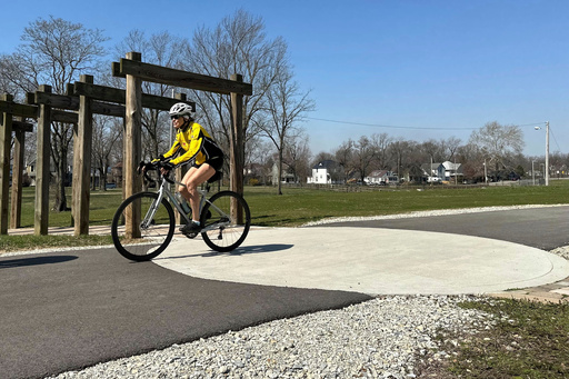 FILE - A cyclist rides along the Cardinal Greenway in Muncie, Indiana, March 13, 2024. (AP Photo/Isabella Volmert, File)