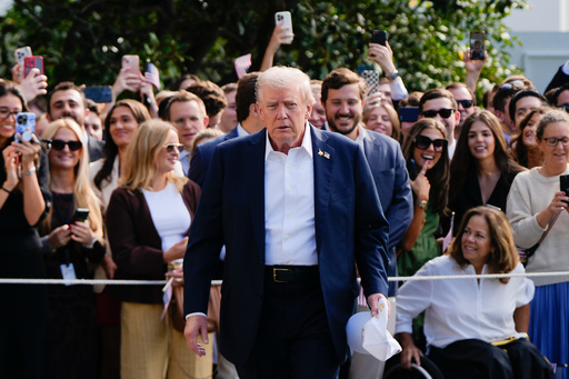 President Donald Trump walks to speak with reporters after greeting supporters before departing the White House, Friday, Sept. 26, 2025, in Washington. (AP Photo/Julia Demaree Nikhinson)