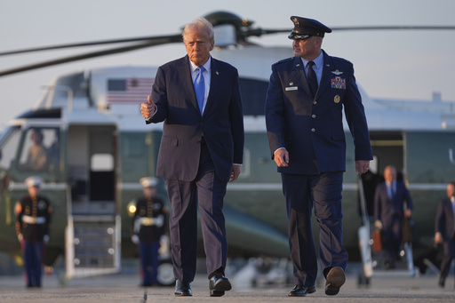 President Donald Trump walks from Marine One with Col. Christopher Robinson, right, commander of the 89th Airlift Wing, to board Air Force One at Joint Base Andrews, Monday, Sept. 22, 2025, at Joint Base Andrews, Md. (AP Photo/Evan Vucci)