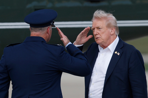 President Donald Trump, right, salutes Air Force Col. Christopher M. Robinson, Commander, 89th Airlift Wing, before boarding Marine One upon his arrival at Joint Base Andrews, Md., Friday, Sept. 26, 2025, after a day trip to the Ryder Cup golf tournament at Bethpage Black in Farmingdale, N.Y. (AP Photo/Luis M. Alvarez) (AP Photo/Luis M. Alvarez)