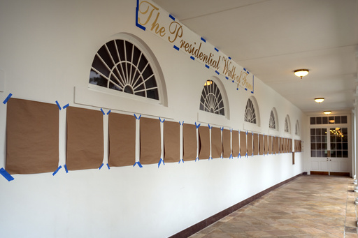 A sign reading "The Presidential Walk of Fame" and pieces of brown paper are taped along the wall of the White House colonnade next to the Rose Garden, Sunday, Sept. 21, 2025, in Washington. (AP Photo/Mark Schiefelbein)