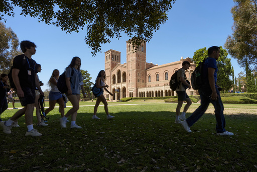 FILE - Students walk past Royce Hall at the UCLA campus in Los Angeles, Aug. 15, 2024. (AP Photo/Damian Dovarganes, File)