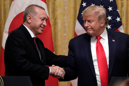 FILE - President Donald Trump shakes hands with Turkey's President Recep Tayyip Erdogan after a news conference in the East Room of the White House, Nov. 13, 2019, in Washington. (AP Photo/ Evan Vucci, File)