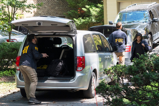 A group of FBI agents leave former national security adviser John Bolton's house where FBI searched the home, Friday, Aug. 22, 2025, in Bethesda, Md. (AP Photo/Manuel Balce Ceneta)