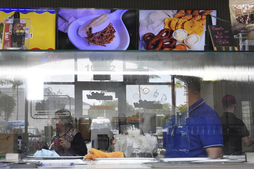 FILE - Employees work inside a franchise of "Sabor Venezolano," one of 18 businesses owned by Wilmer Escaray which employ scores of Venezuelan immigrants with Temporary Protected Status (TPS) in Doral, Fla., May 20, 2025. (AP Photo/Rebecca Blackwell, File)