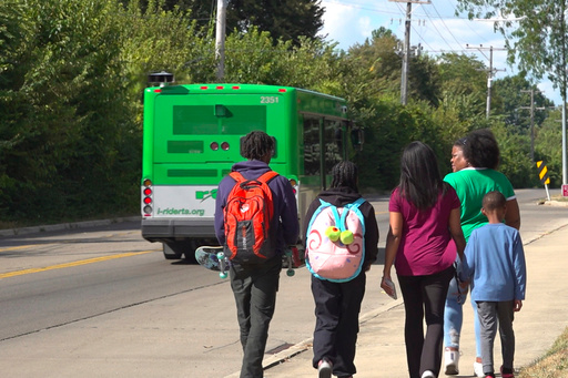 This photo taken from video shows, from left, Kenneth Moore Jr, Suelonnee Tingle, Shonnee Hullum, Sage Harrington and Ronnee Tingle, right front, walking to Ronnee Tingle's car after Moore and Suelonnee Tingle were dropped off by an RTA bus after school Wednesday, September 3, 2025 in Dayton, Ohio. (AP Photo/Patrick Aftoora-Orsagos)