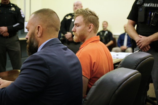 Shotsie Buck-Hayes sits beside defense attorney Edward Lavado in the General District Courtroom in during a preliminary hearing in Danville, Va., Tuesday, Sept. 30, 2025. He is charged with setting a city councilman on fire in July. (AP Photo/Allen G. Breed)