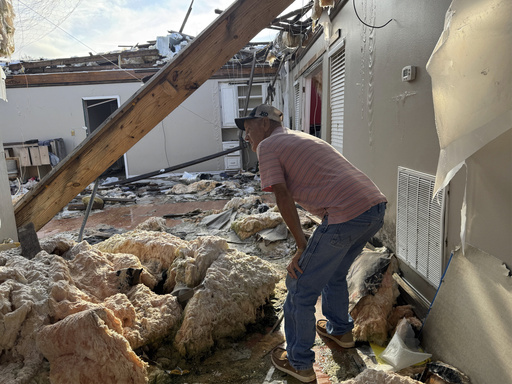 Buddy Anthony surveys the remnants of his home on Thursday, Aug. 14, 2025, in Tylertown, Miss. (AP Photo/Sophie Bates)