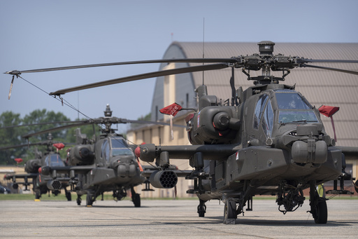 FILE - U.S. Army AH-64E Apache helicopters are pictured at Joint Base Andrews, Md., June 12, 2025. (AP Photo/Mark Schiefelbein, File)