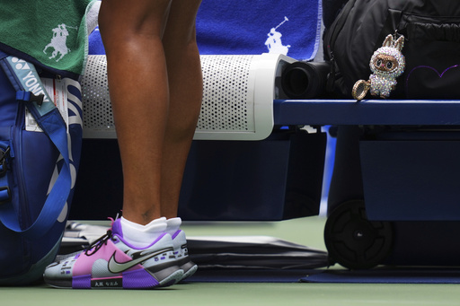 A Labubu doll sits near Naomi Osaka, of Japan, before her match against Coco Gauff, of the United States, during the fourth round of the US Open tennis championships, Monday, Sept. 1, 2025, in New York. (AP Photo/Kirsty Wigglesworth)