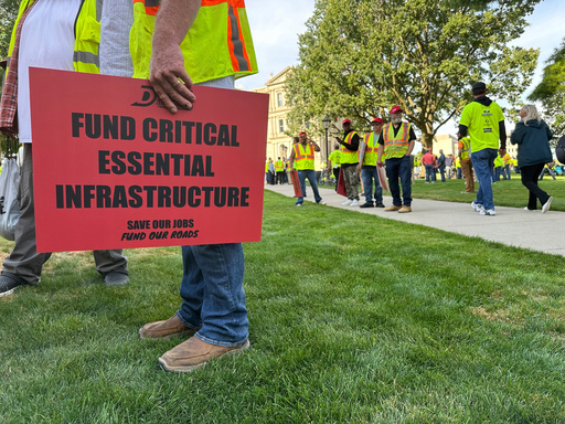Construction workers gather at Michigan's statehouse in Lansing, Mich., Wednesday, Sept. 3, 2025, to call for a long-term road funding solution as a state government budget deadline approaches. (AP Photo/Isabella Volmert)