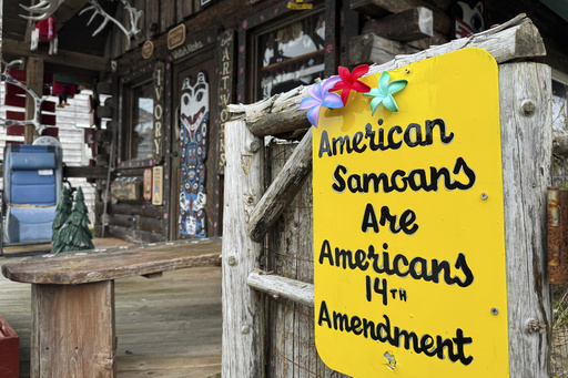 FILE - A sign supporting citizenship for American Samoans is posted outside the Log Cabin Gifts store on the waterfront in Whittier, Alaska, May 13, 2025. (AP Photo/Mark Thiessen, File)