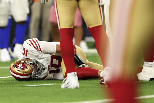 San Francisco 49ers quarterback Mac Jones remains on the ground after a play during the second half of an NFL football game against the Los Angeles Rams, Thursday, Oct. 2, 2025, in Inglewood, Calif. (AP Photo/Jessie Alcheh)